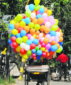 Colourful balloons are ferried for sale on a rickshaw in Amritsar.