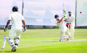 Players in action during a cricket match between Madhya Pradesh and Uttar Pradesh at Sector 26 in Chandigarh on Monday. 