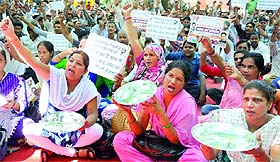 Delhi Home Guard activists shout slogans during a demonstration near Home Minister Rajnath Singhs residence in New Delhi on Monday.
