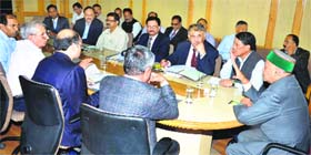 Chief Minister Virbhadra Singh presides over the meeting regarding the four-laning Parwanoo-Shimla road project in Shimla on Monday