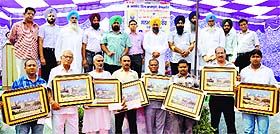 Ajmer Singh Bhagpur (yellow turban), chairman, Verka Milk Plant, along with the dealers who were honoured at a function in Ludhiana. 