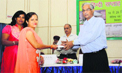 A participant being awarded at the conclusion of the Hindi Week at ICFRE in Dehradun on Monday. A Tribune photograph