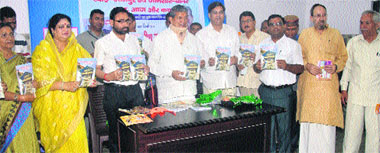 Chief Minister Harish Rawat releases a book at a function in Dehradun on Monday. a tribune photograph