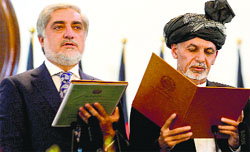 Newly-sworn in Afghan President Ashraf Ghani (R) administers the oath to Abdullah Abdullah (L) as Afghanistans new Chief Executive in Kabul on Monday. AFP