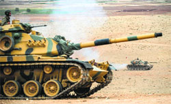 Turkish army tanks take position near the Syrian border in Suruc after three mortars hit the Turkish side on Monday. AFP