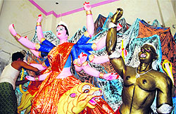 An artist gives final touches to an idol of Goddess Durga in Amritsar on Tuesday