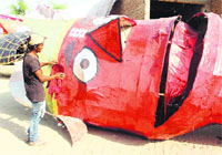 An artist gives final touches to an effigy of Ravana at Partap Nagar in Bathinda on Tuesday. photo: vijay kumar