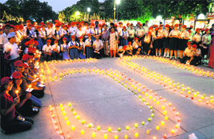Students take part in a candlelight walk organised by the Blood Bank Society at Sector 17, Chandigarh, on Tuesday.