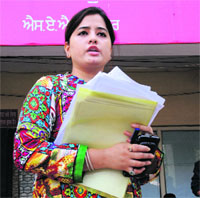 Accused Rashmi Negi adresses mediapersons outside the office of the SSP in Phase I, Mohali.