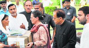 Sonia Gandhi and Rahul Gandhi distribute relief material among flood victims in Jammu on Tuesday. 