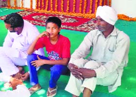 Residents of Badal village in front of a foundation stone on Monday