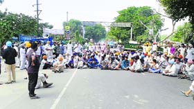 Villagers stage a dharna on Neelon bridge near Ludhiana on Tuesday