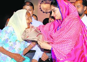 Union Minister Harsimrat Badal honours a pensioner in Jalandhar on Tuesday