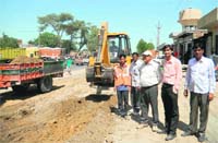 A JCB machine in action along the Hanumangarh highway on Tuesday
