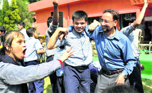 DGP BS Sidhu enjoys light moments with special children at Raphel Home in Dehradun on Tuesday. 