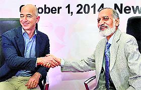 Jeff Bezos (L), CEO of Amazon.com, shakes hands with Kiran Karnik, former NASSCOM president, at a FICCI meeting in New Delhi on Wednesday.