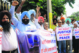 Members of the Aam Adami Party protest outside the DCs office in Mohali on Wednesday. 