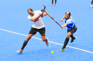 Players vie for the ball during a hockey match between the BSF and the Indian Air Force in Mohali on Wednesday.