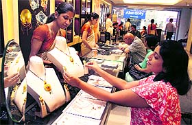 A woman takes a look at the gold jewellery in Jalandhar on Wednesday. 