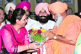 CPS Dr Navjot Kaur Sidhu honours environmentalist Balbir Singh Seechewal during a state-level National Voluntary Blood Donation Day function in Kapurthala on Wednesday. 