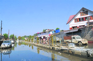 Damaged cars lie in slush after the recent floods in Srinagar.