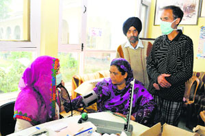 A doctor checks a flood victim at a gurdwara in Bhagat Barzullah on Wednesday. 