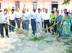 Principal and teachers clean the college campus in Ludhiana.