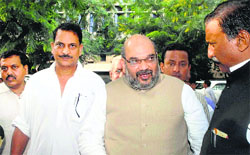 BJP chief Amit Shah (C) and party leader Rajiv Pratap Rudy (L) in Mumbai on Wednesday. PTI