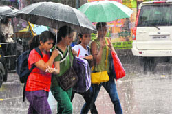 Girls walk with umbrellas in rain in Dehradun on Wednesday. Tribune photo: Abhyudaya Kotnala