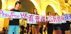 Students from Taiwan and Hong Kong display placards in front of the Freedom Square during a gathering in support of pro-democracy protesters, in Taipei on Wednesday. AFP
