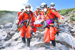 Firefighters carry a hiker during rescue operations on Mount Ontake in central Japan. The death toll from Japans volcanic eruption rose to 48 on Wednesday, the worst in 88 years. Reuters