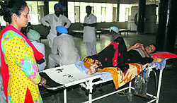An attendant pushes a stretcher carrying a patient all by herself at a government hospital in Amritsar on Thursday