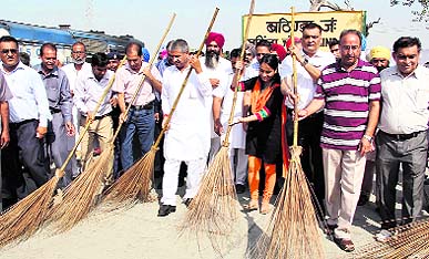 Chief Parliamentary Secretary and Bathinda MLA Sarup Chand Singla and ADC (D) Sonali Giri hold brooms to encourage the public to participate in the Swachh Bharat Abhiyan in Bathinda on Thursday. 
