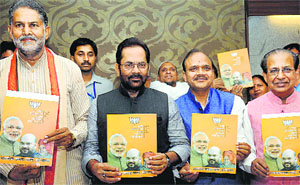 Haryana BJP president Ram Bilas Sharma (left), Mukhtar Abbas Naqvi (second from left) and other leaders release the party manifesto in Chandigarh on Thursday.