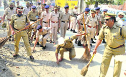 Officers of the Central Reserve Police Force clean the lanes in the old town of Srinagar on Thursday. Tribune photo: Amin war