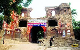 Labourers on job for the repair of Lahori Gate at Sultanpur Lodhi on Thursday.