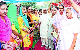 Young village girls welcome invitees to dhian da mela at Thuhi village in Patiala on Thursday. 