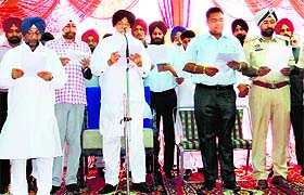 Chief Minister Parkash Singh Badal administers oath to the public during a state-level function at Shekhpura village near Talwandi Sabo on Thursday.