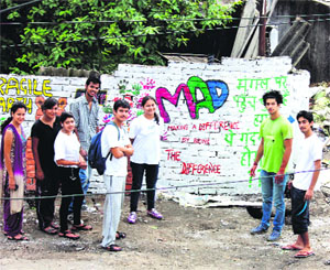 Volunteers of Making a Difference paint the walls on the occasion of a cleanliness drive on Gandhi Jayanti in Dehradun on Thursday.