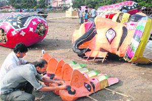 A day ahead of Dasehra festival, artistes giving final shape to a dummy of Ravana at Parade Ground in Dehradun on Thursday.