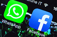 This file picture taken in Rome shows the Facebook and WhatsApp applications icons displayed on a smartphone