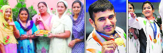 Indian Kabaddi player Ajay Thakurs mother (centre) shares sweets at Dhabota village in Nalagarh after India bagged a gold in kabaddi in the Asian Games; and (right) Ajay Thakur and Pooja Thakur celebrate their win at Incheon. Tribune photo & PTI