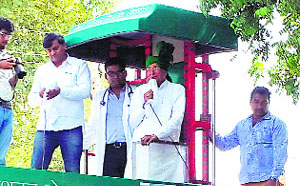 Standing atop specially designed vehicle, INLD supremo OP Chautala seeks votes for grandson Dushyant Chautala at Uchana Kalans Palwah village in Jind district on Friday