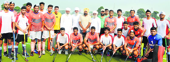 Players and officials pose for a photograph. a tribune photograph