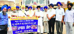 Office-bearers of Gurdwara Dukh Niwaran Sahib flag off a truck loaded with relief material to J &K, in Ludhiana. Photo: Inderjeet Verma