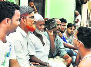 People listen to Prime Minister Narendra Modis radio address Man Ki Baat in Lucknow on Friday.