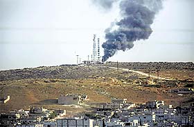 Smoke rises from the Syrian town of Ain al-Arab, known as Kobane by the Kurds, on Friday.