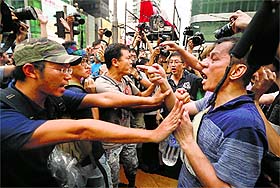 Pro-democracy protesters (L) stop anti-Occupy Central protesters from going near their tent at Hong Kongs Mongkok shopping district on Friday.