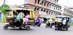 Overcrowded auto-rickshaws ply on a road in Amritsar on Saturday