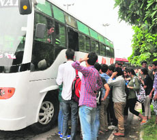 Students board a bus to attend a party allegedly organised by a student party before the elections at Panjab University.